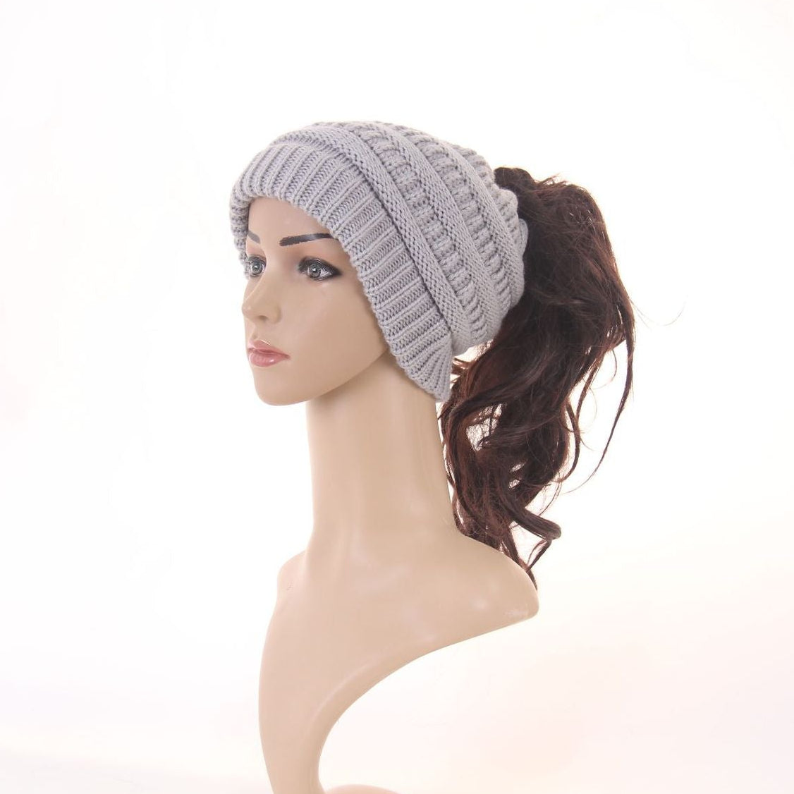 Gray knitted headband worn by a mannequin on a white background