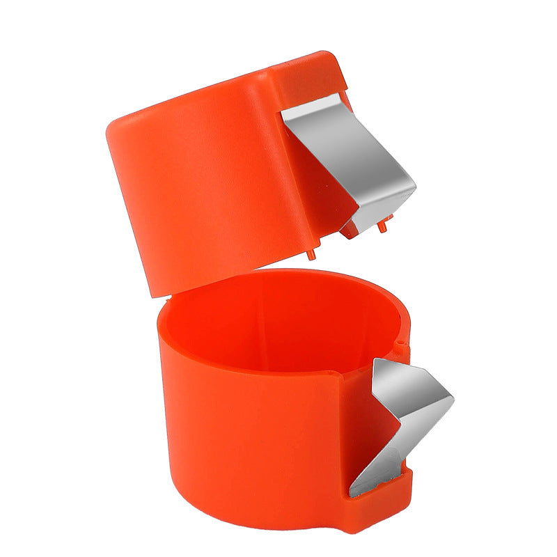Orange plastic egg opener with silver clips on a white background