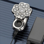 Silver electric razor with digital display on a dark background