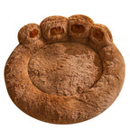 Brown paw-shaped pet bed on a white background