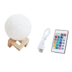 White spherical moon lamp with wooden stand, USB cable, and remote control on a white background